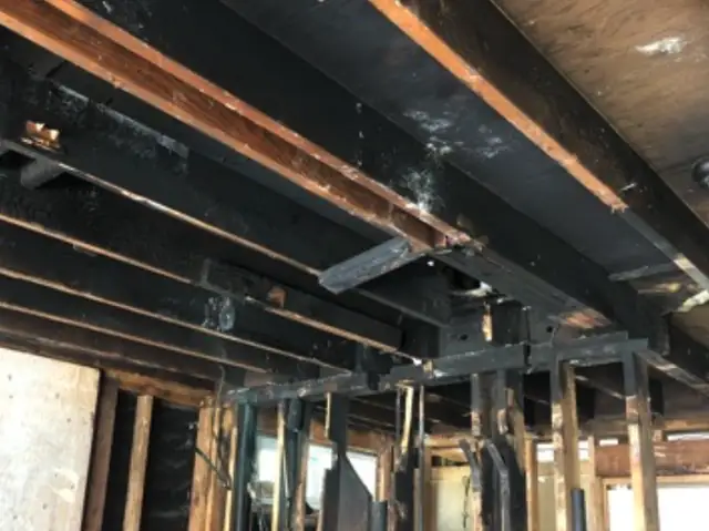 Fire-charred ceiling joists and framing