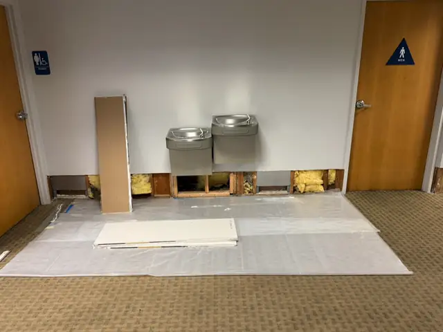Drywall cut out of a wall to dry the wet area